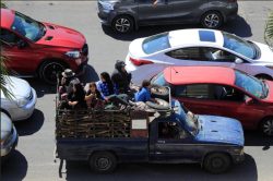 A girl looks up from a packed trailor stuck in traffic, Lebanon