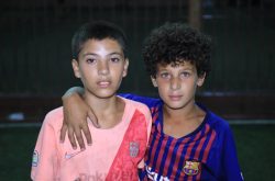Two Paletstinian boys in football shirts